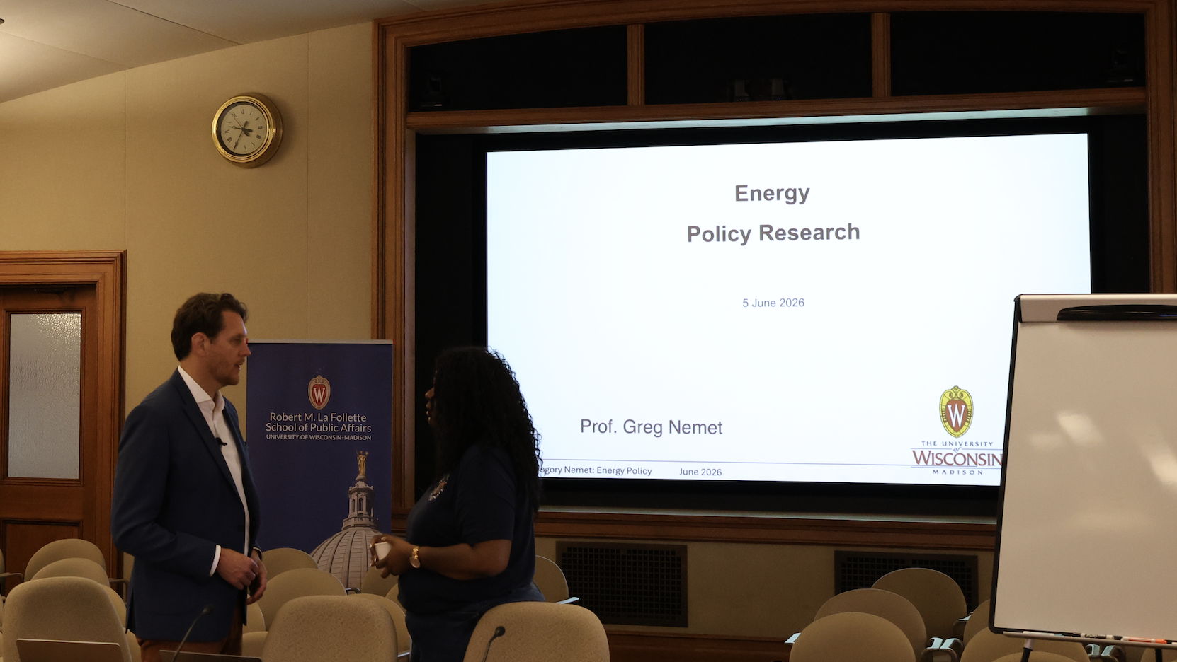 Professor answering staff member questions.