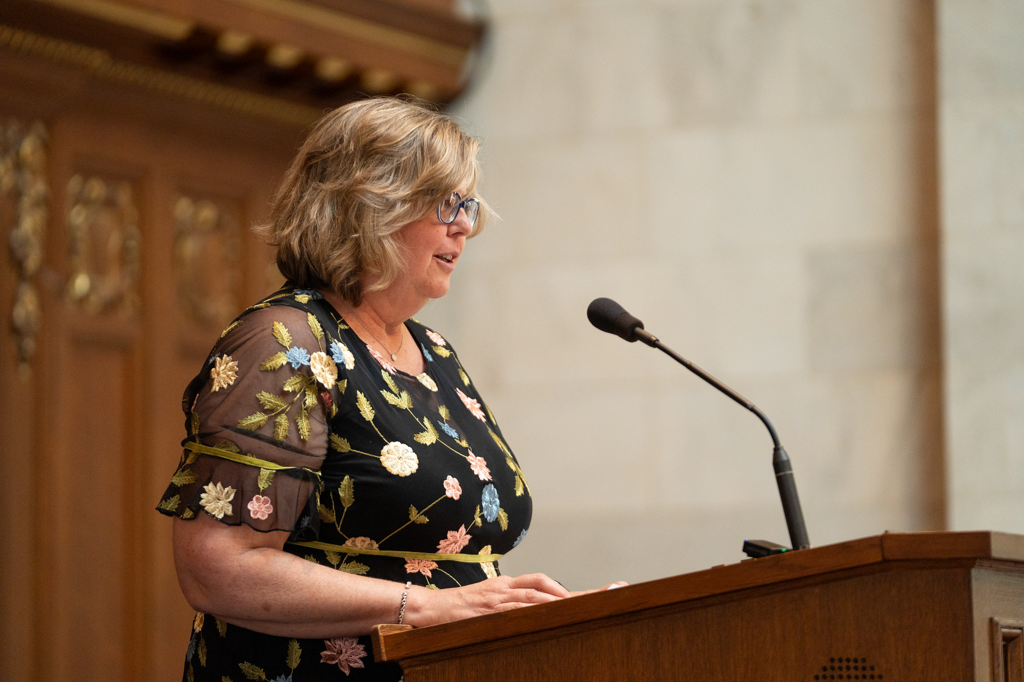 Mo O'Connor stands at a lectern speaking