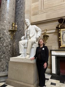 Anna standing next to a statue.