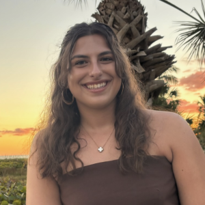 Hayley smiling in front of a sunset.