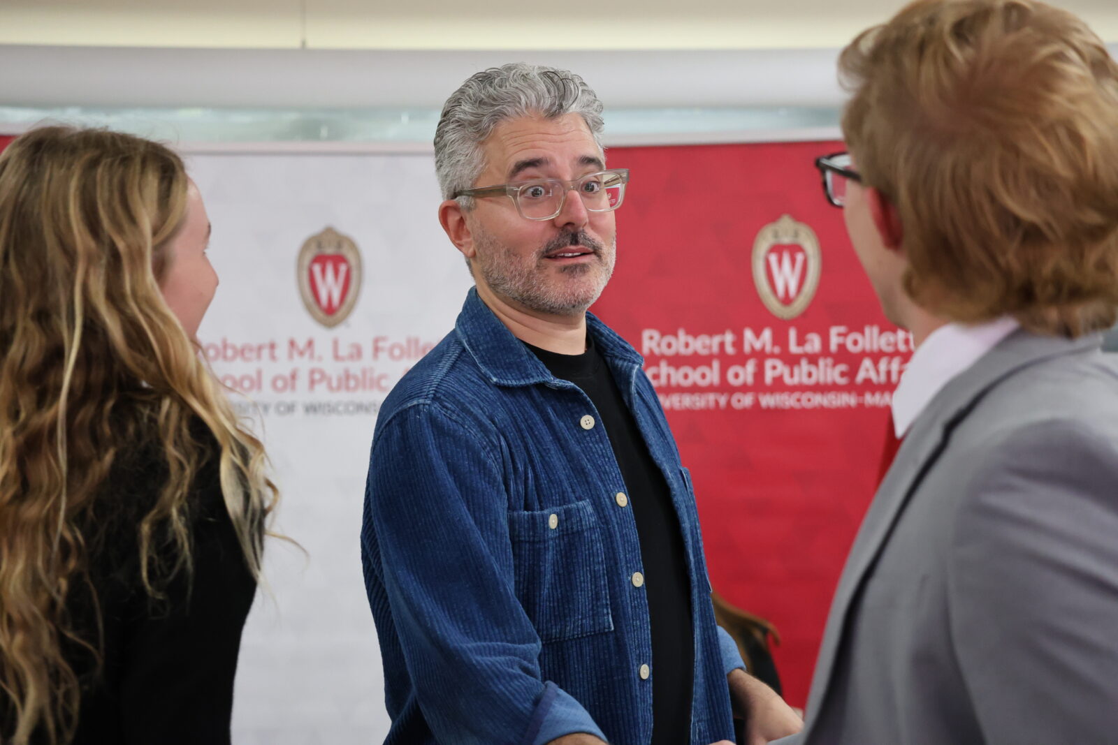 Michael Barbaro greets undergraduate students after a class visit.