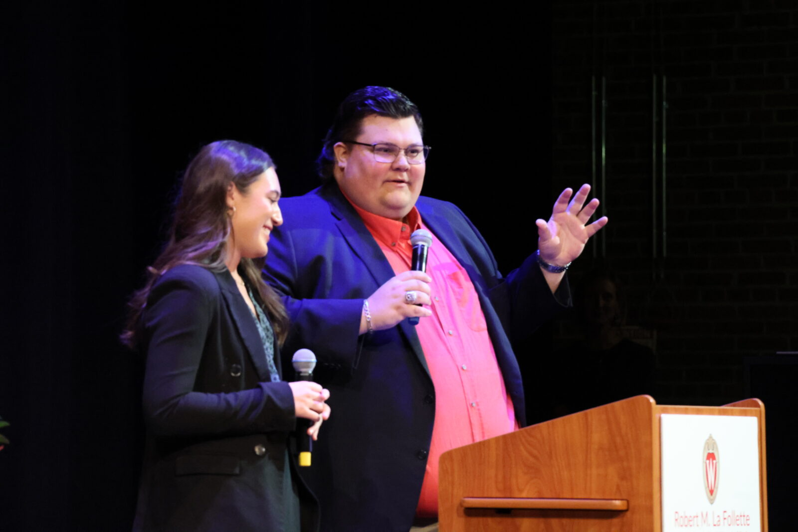 Two students speaking at a podium in Shannon Hall