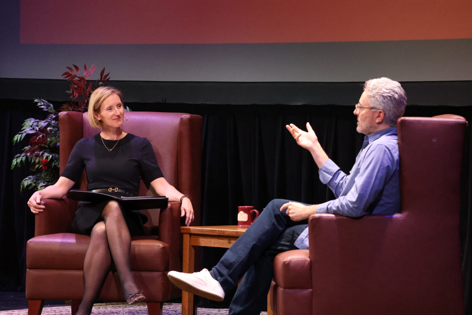Michael Barbaro and Susan Yackee speaking on stage