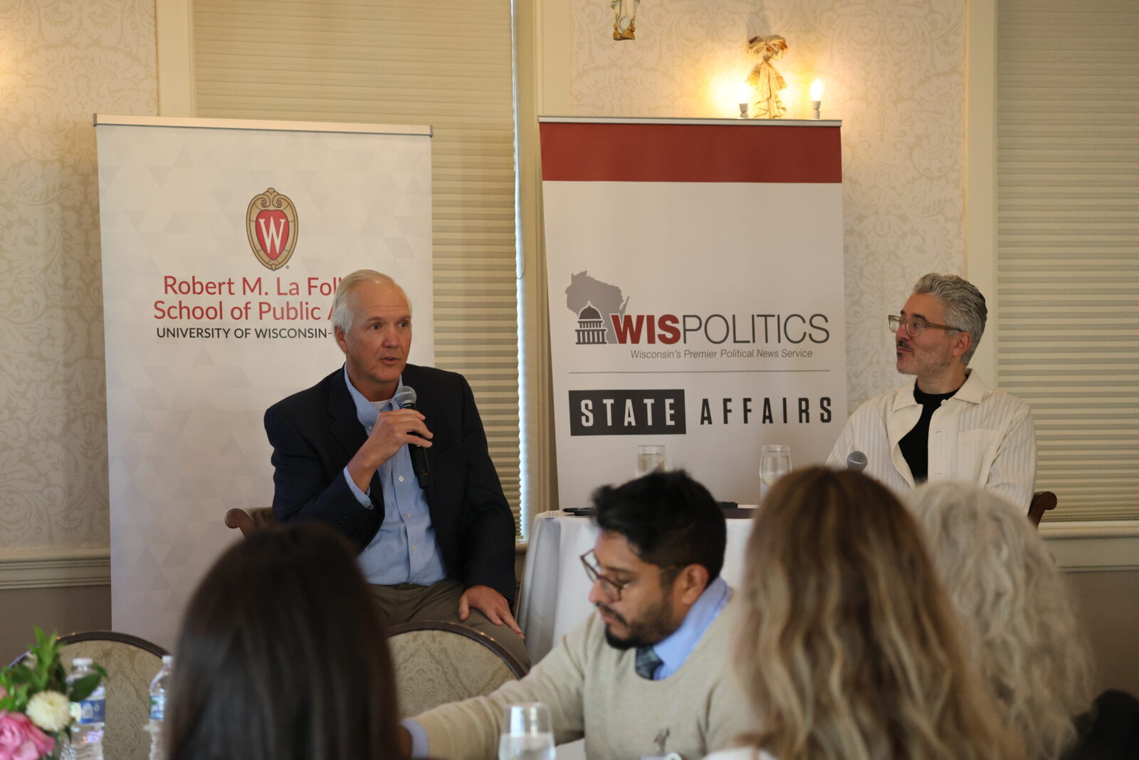 Michael Barbaro and Jeff Mayers speaking at the front of the room